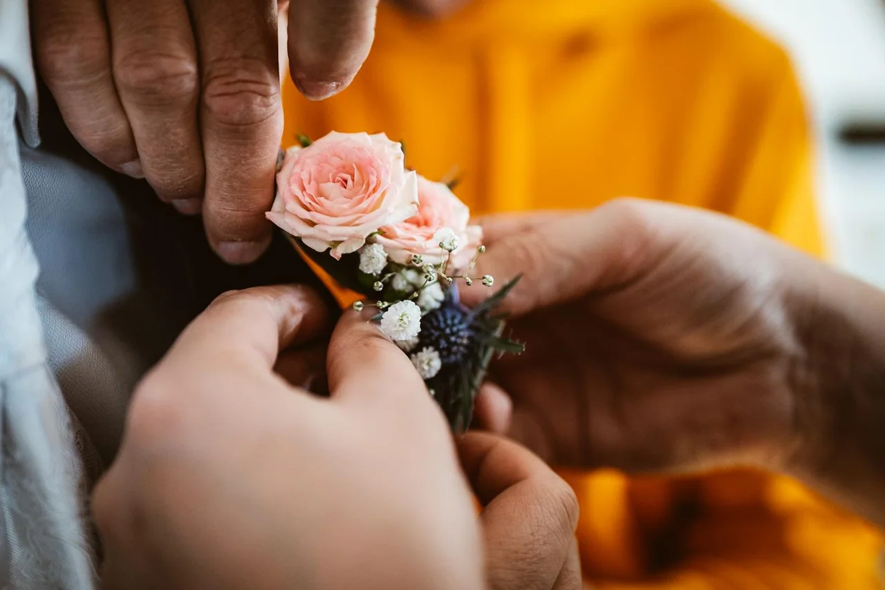 Eine Ansteckblume wird befestigt